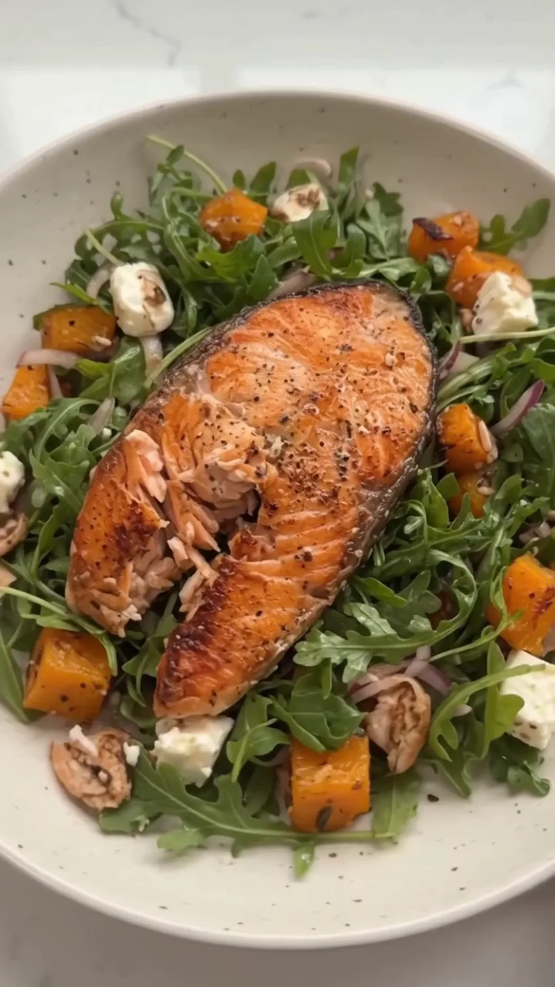 Honey-Glazed Salmon and Roasted Pumpkin Salad – Salmon fillet is being cooked in an oven