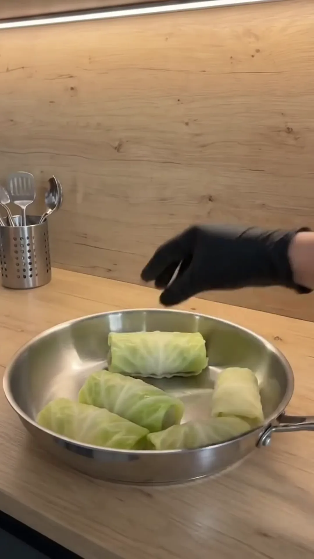 Individual Stuffed Cabbage Rolls with Ground Beef and Rice – person placing cabbage rolls in a pan