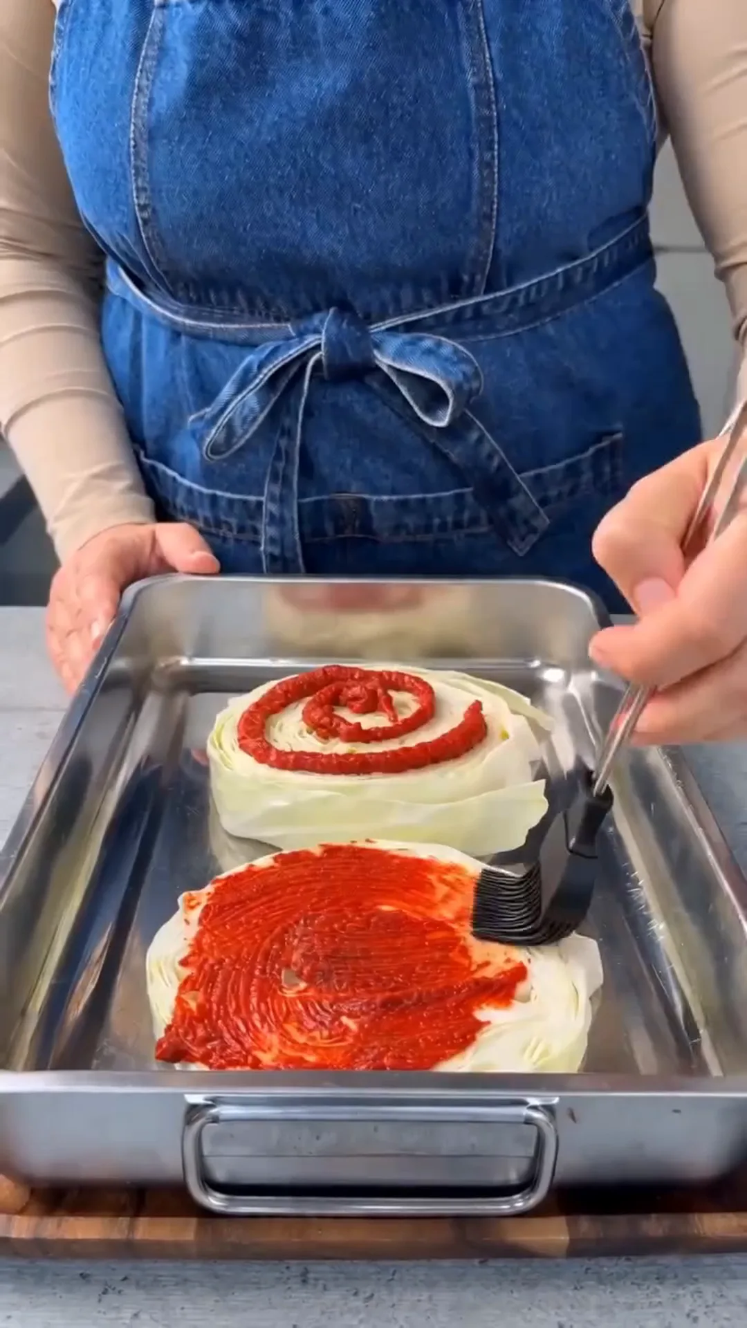 Italian Unrolled Cabbage Rolls with Creamy Tomato Sauce – applying a red sauce to a white food item