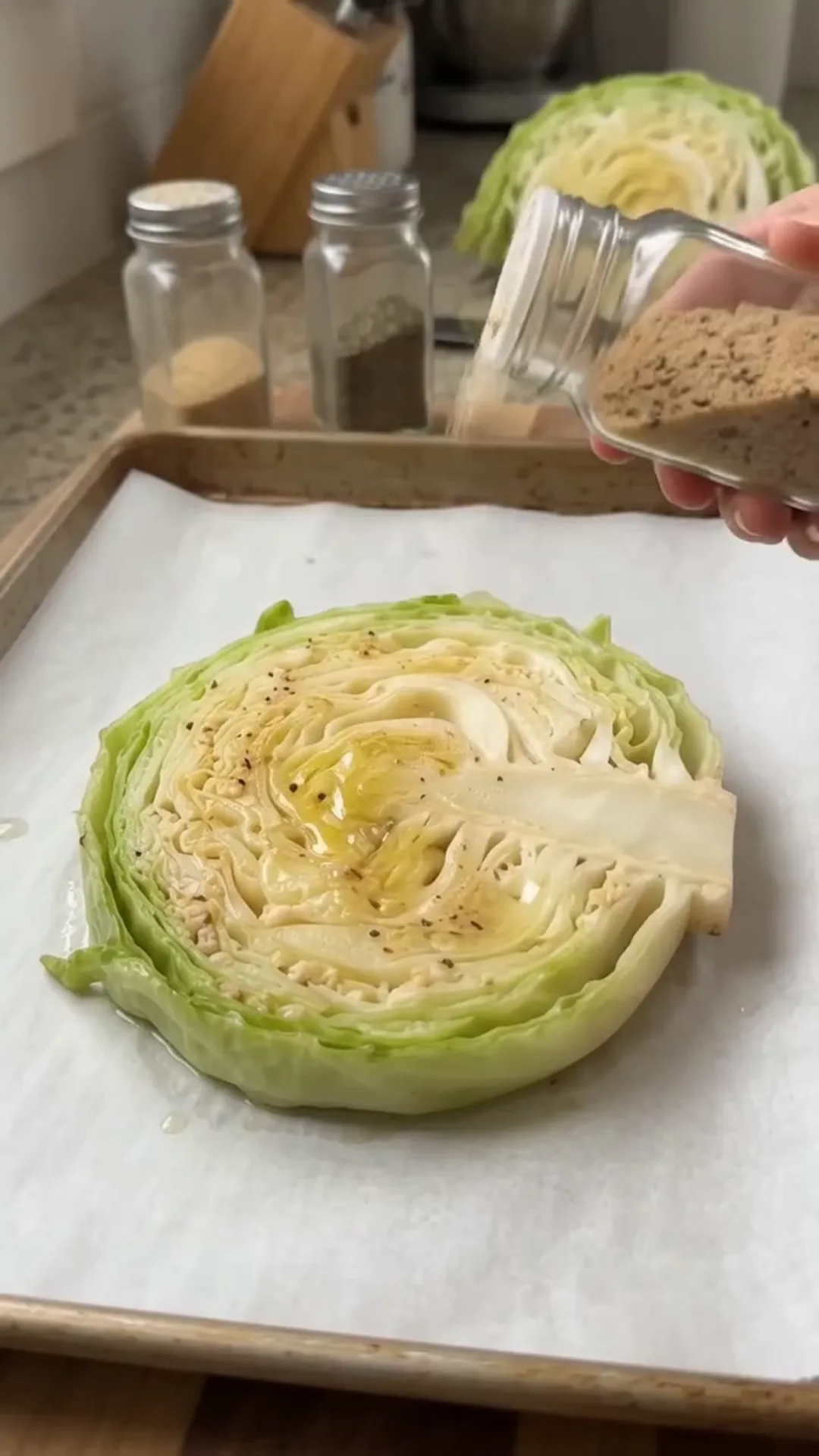 Loaded Cabbage Steaks with Ground Chicken and Mozzarella – Seasoning cabbage with spices, likely before baking