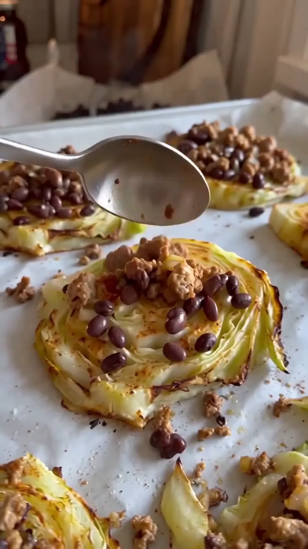 Loaded Taco Cabbage Steaks with Beef and Crema – A person is adding chocolate chips to a baked dessert