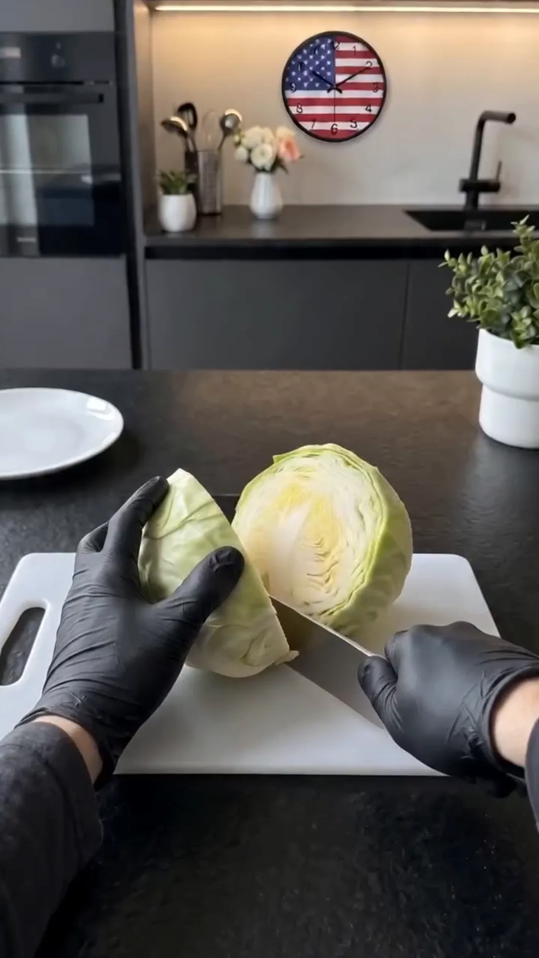 Miso Glazed Cabbage Flowers with Tahini and Cashews – Someone is cutting a head of lettuce on a white cutting board