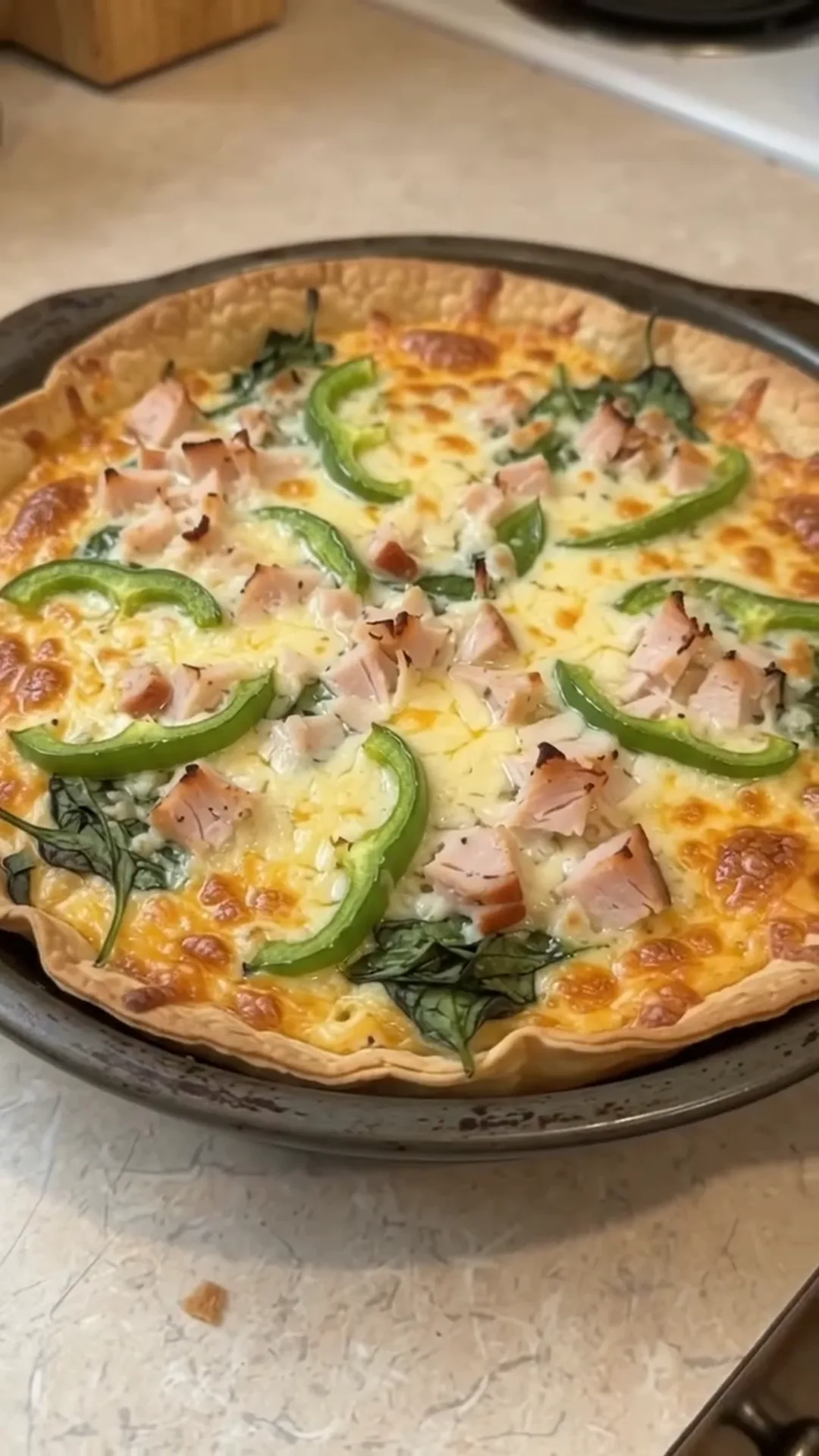 Quick Cauliflower Pizza Steaks with Smoked Turkey and Cheese – A quiche is being prepared, with ingredients on top