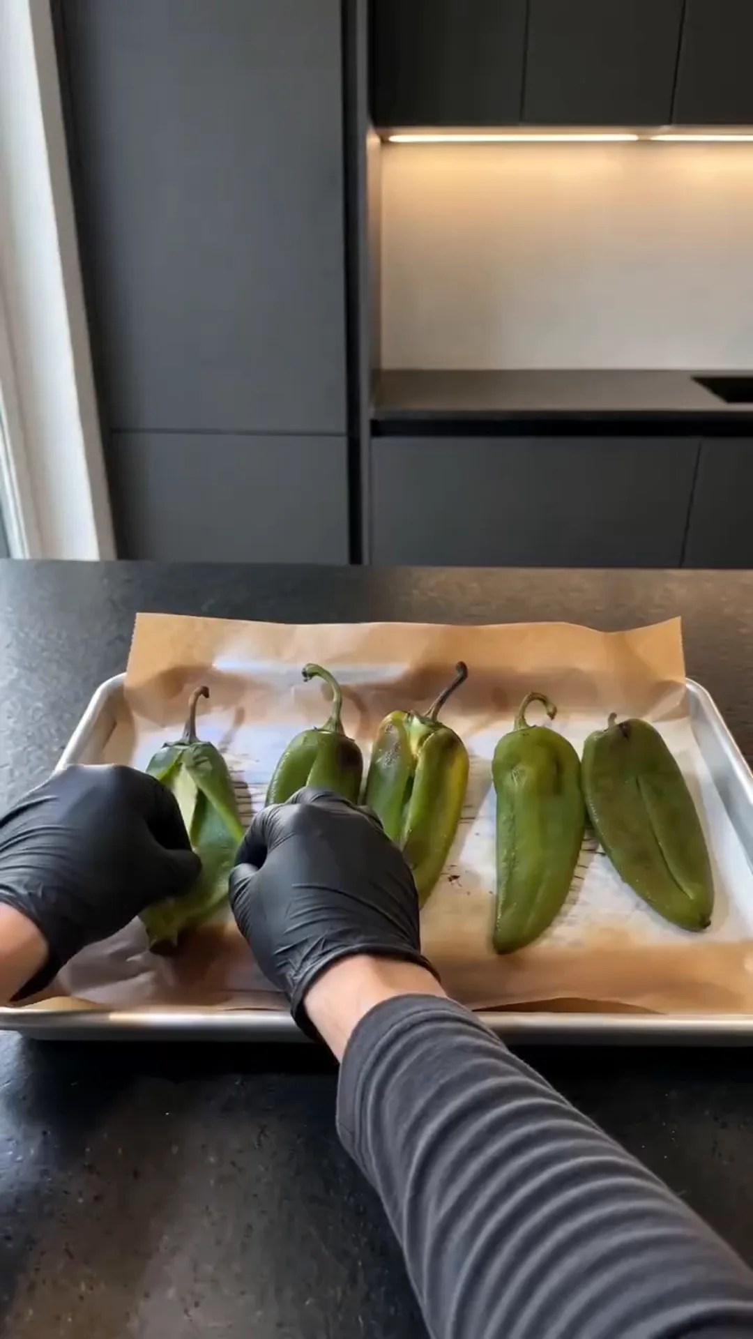 Roasted Anaheim Chile Tacos with Seasoned Beef and Cheese – person preparing peppers on a baking tray