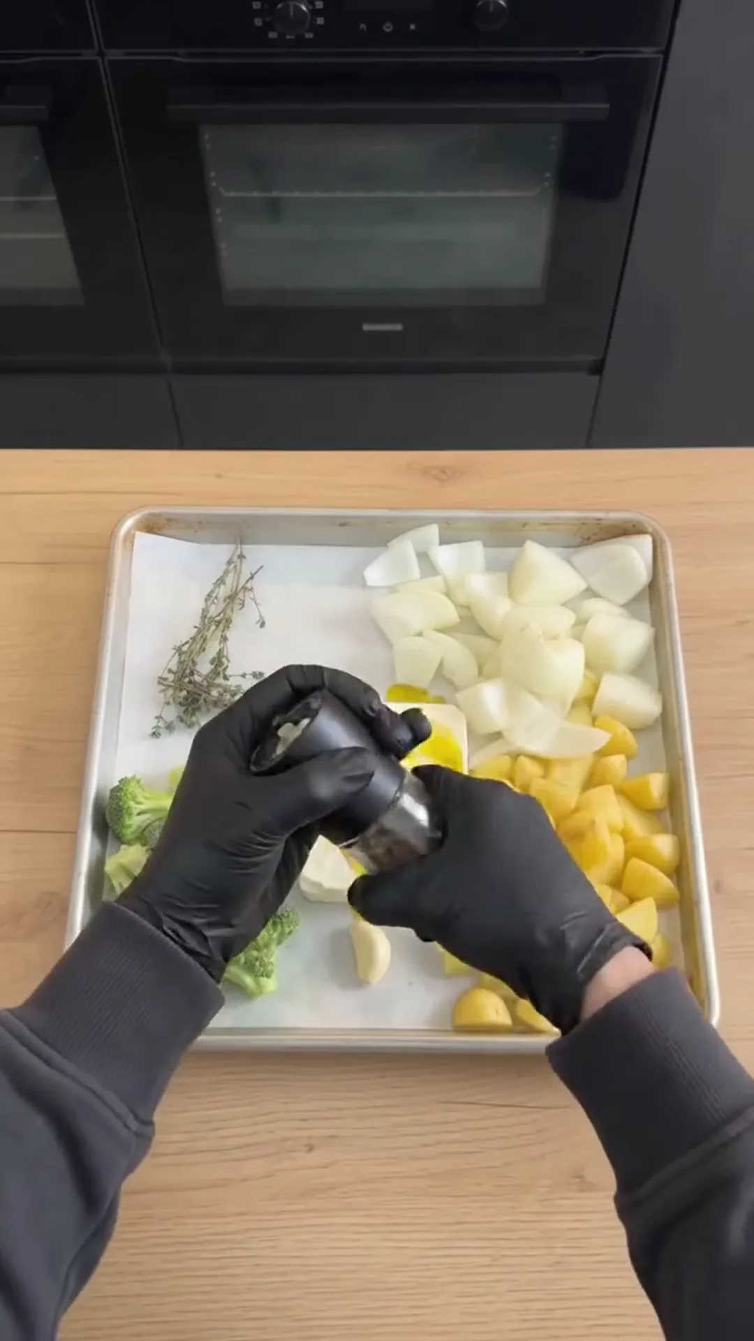 Roasted Broccoli and Feta Soup with Roasted Garlic – Spraying oil on vegetables on a baking tray