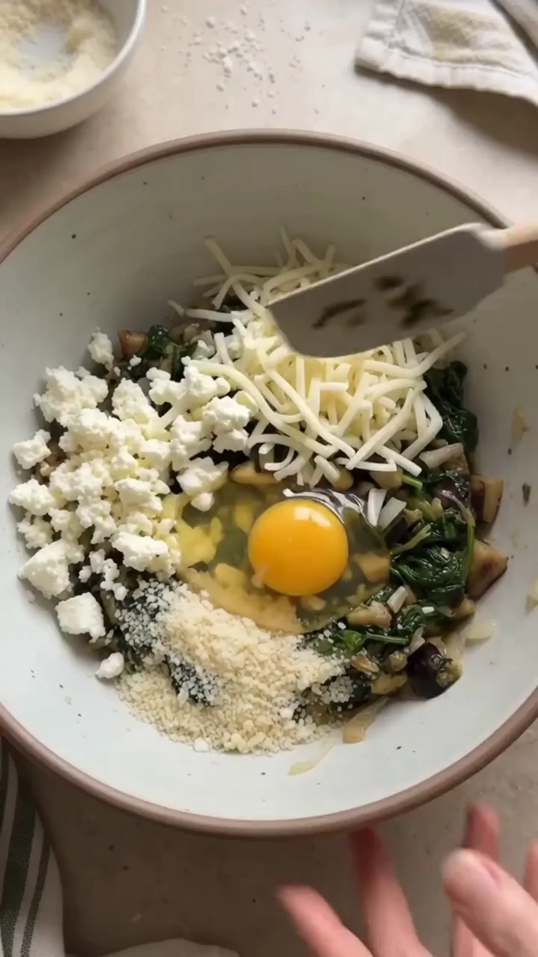 Roasted Spinach and Cheese Stuffed Eggplant Rounds – mixing ingredients in a bowl
