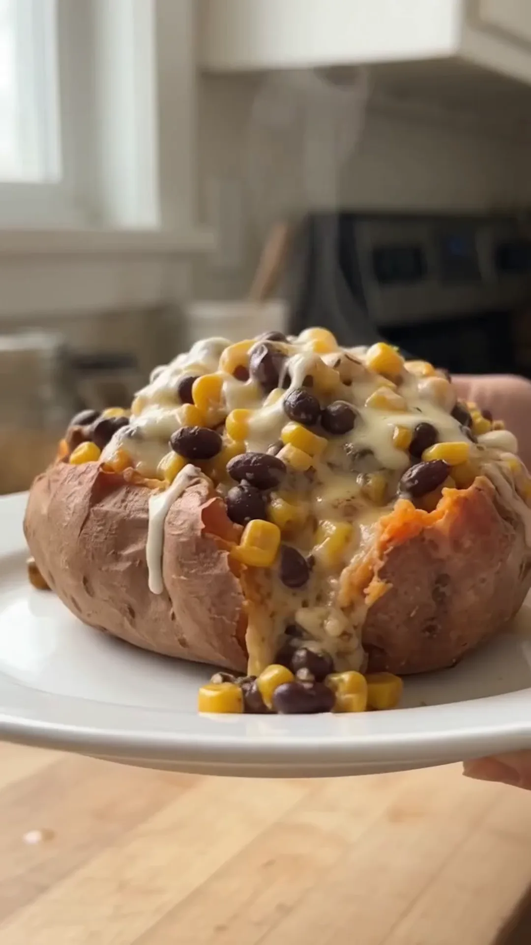 Roasted Stuffed Sweet Potatoes with Seasoned Beef and Corn – a baked sweet potato is being topped with cheese and corn