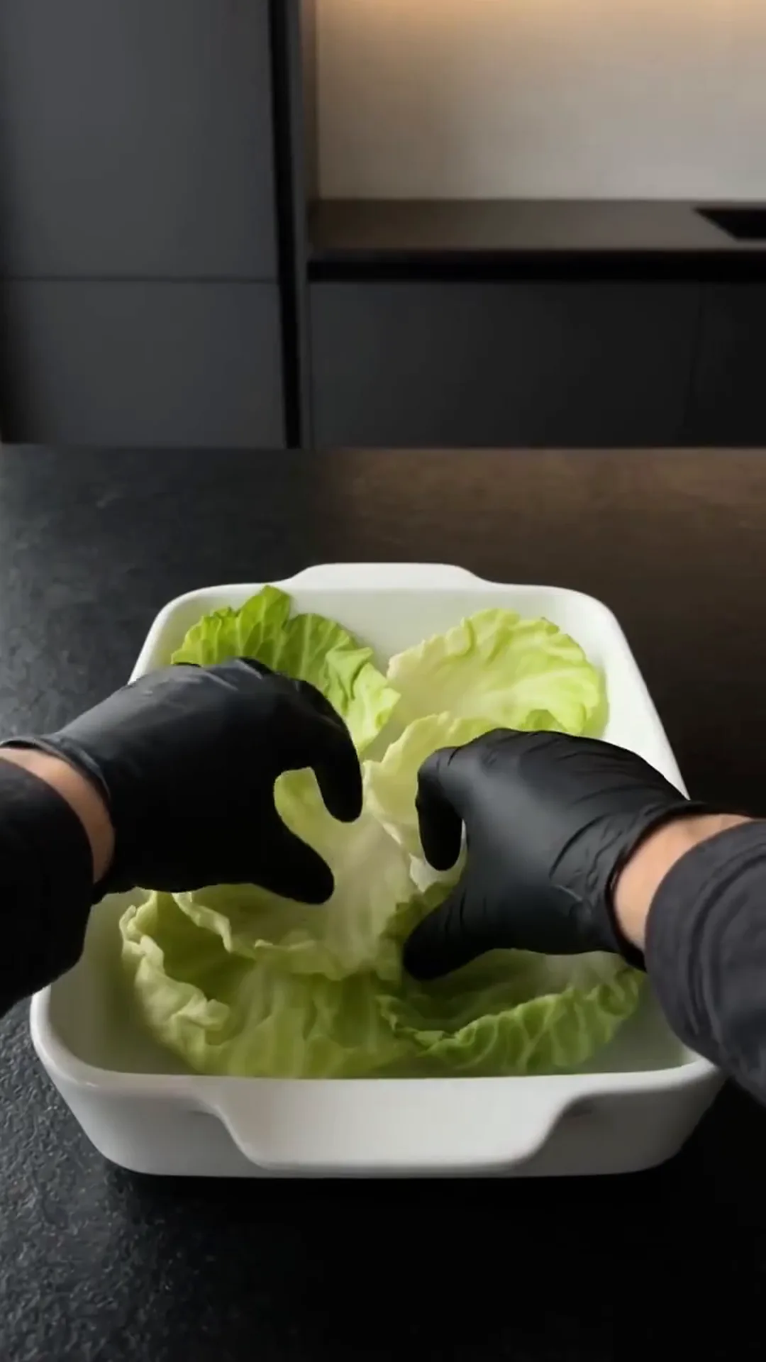 Savory Cheeseburger Cabbage Cups with Melted Cheese – person is washing lettuce in a white bowl