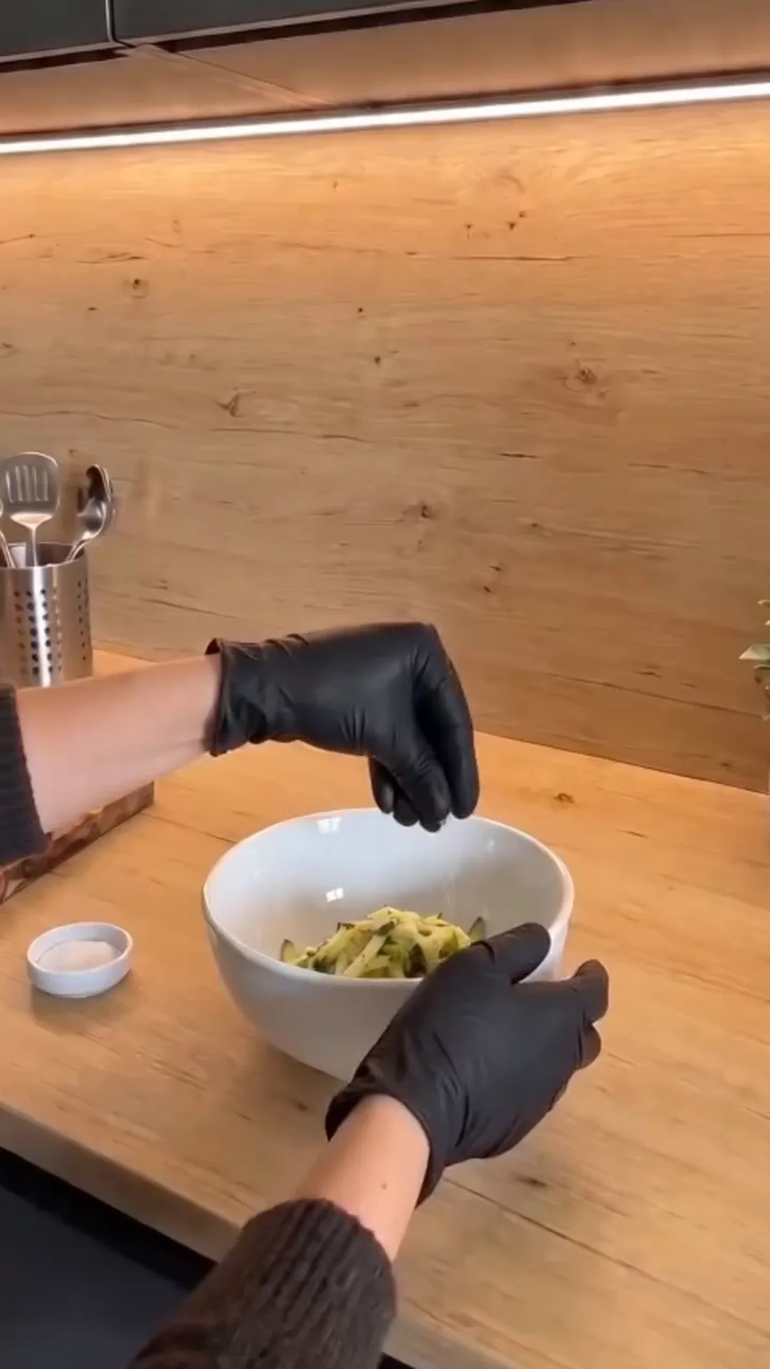 Savory Cheesy Baked Zucchini Loaf with Melted Center – person preparing food in a bowl with black gloves