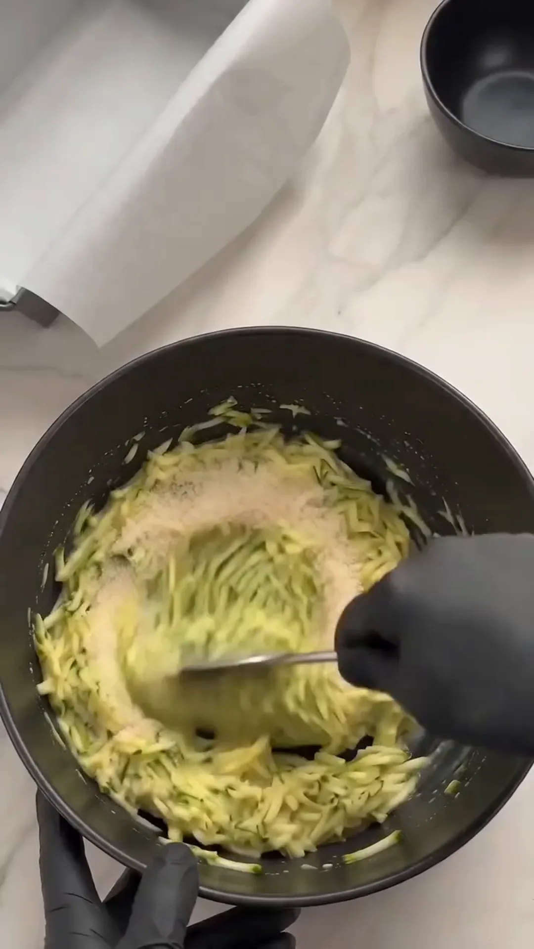Savory Cheesy Baked Zucchini Loaf with Melted Center – person mixing ingredients in a bowl