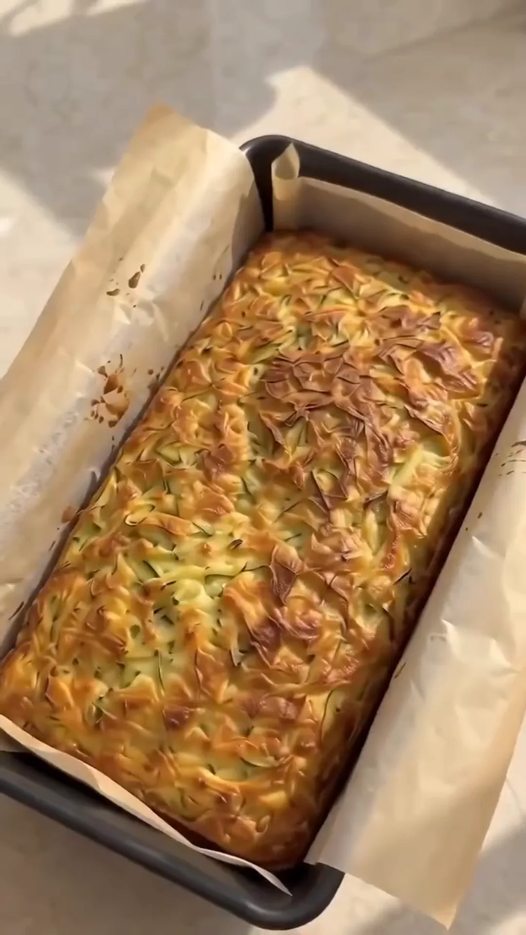 Savory Cheesy Baked Zucchini Loaf with Melted Center – A rectangular dish is being baked in an oven