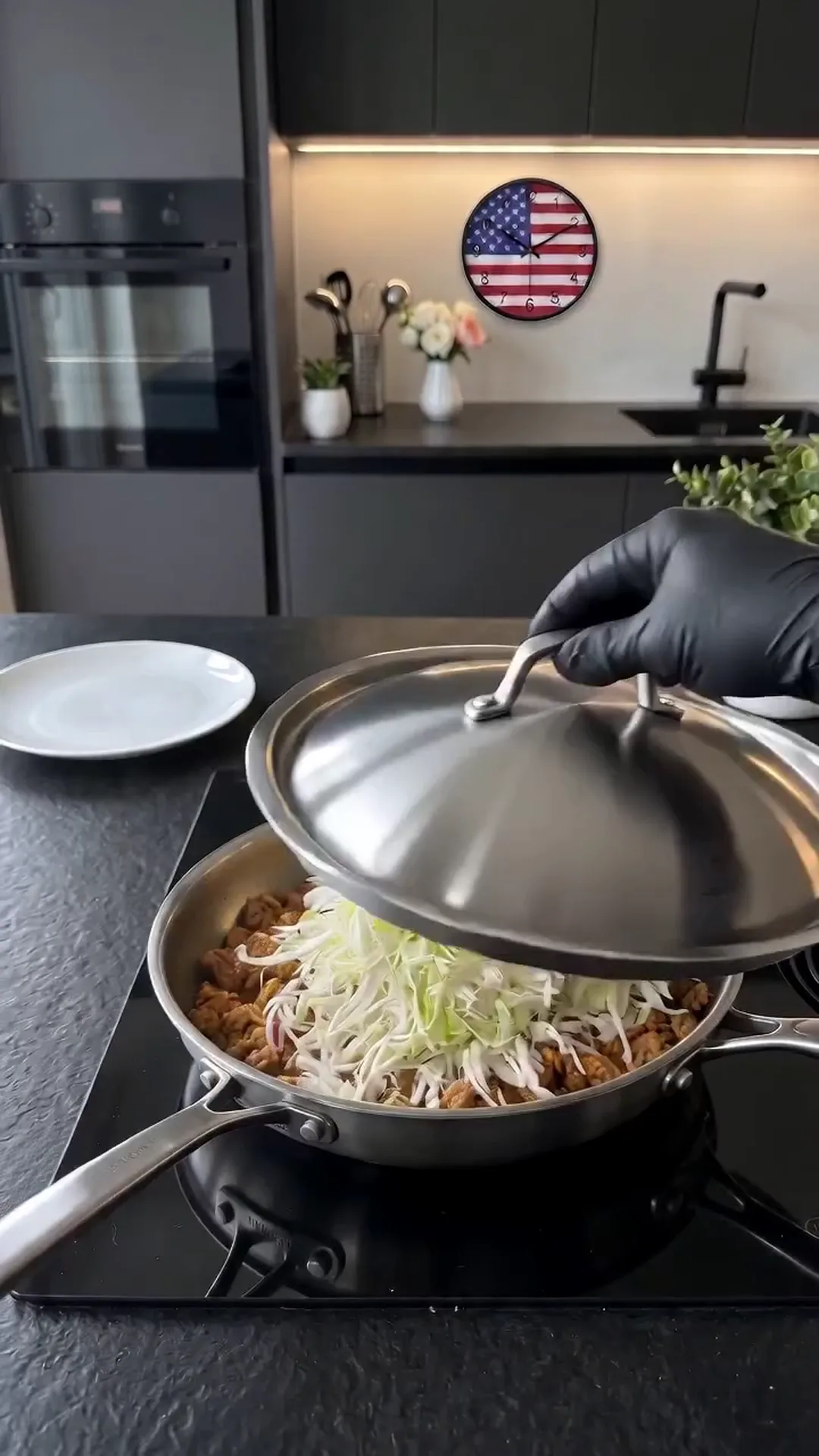 Savory Pan-Seared Cabbage and Ground Chicken Skillet Recipe – A person is cooking a dish with a lid on a pan