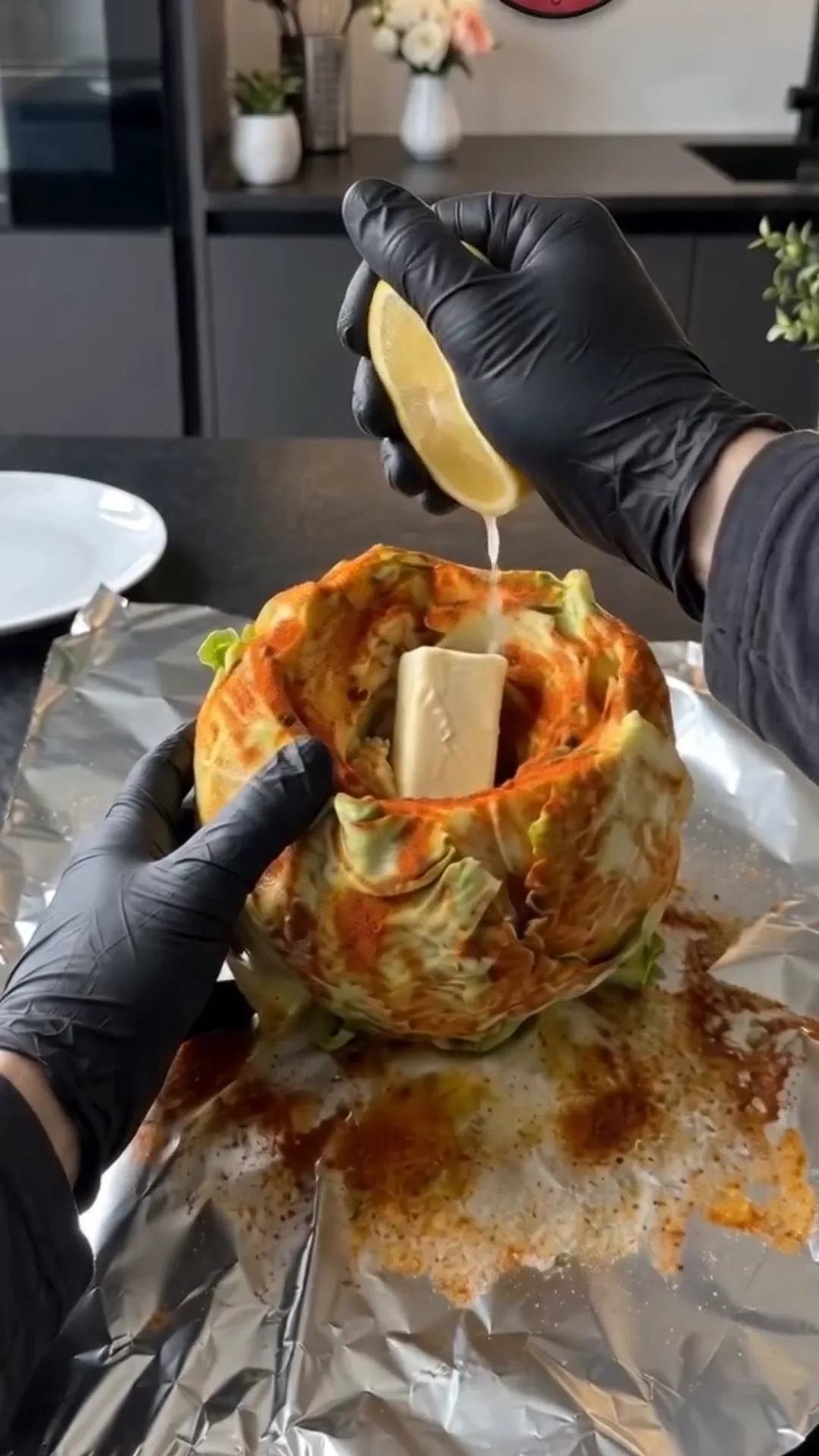 Slow Roasted Whole Cabbage with Savory Butter Sauce – Squeezing lemon juice into a cabbage head