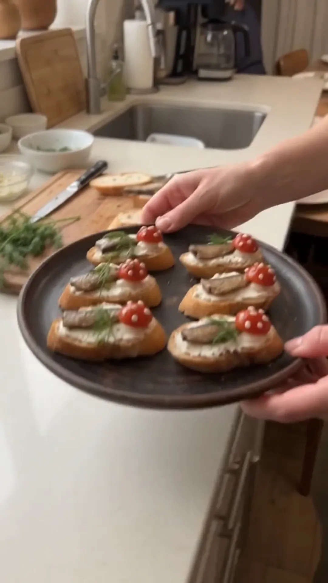 Smoked Sprat and Cream Cheese Baguette Bites – A person is preparing small appetizers on a plate