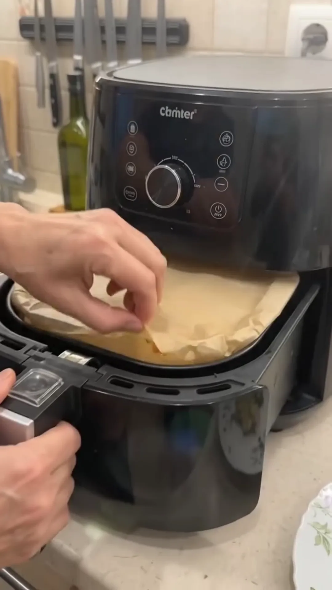 Smoked Turkey and Broccoli Egg Frittata Bake – person placing food in air fryer basket