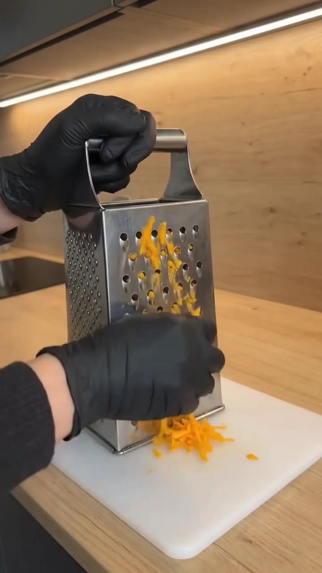 Spiced Pumpkin Loaf Cake with Cream Cheese Filling – Grating cheese on a metal grater