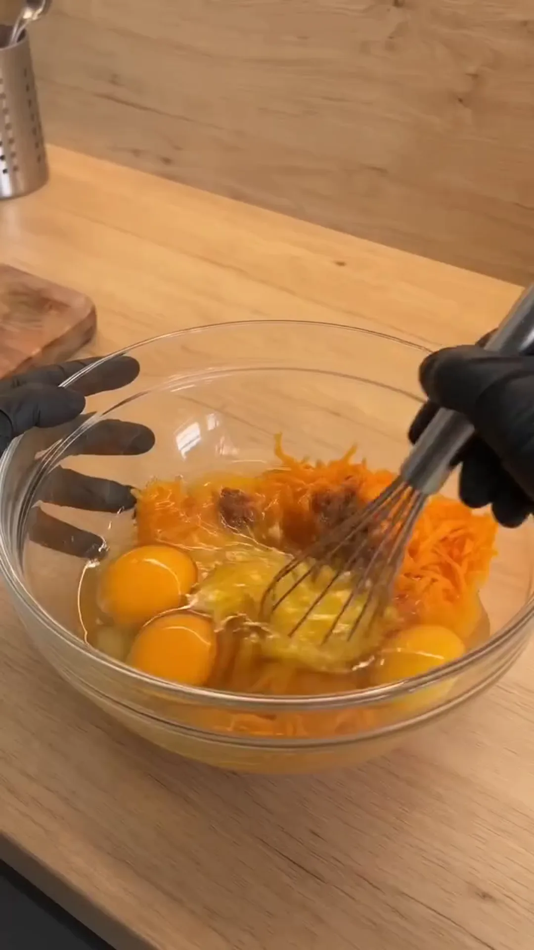 Spiced Pumpkin Loaf Cake with Cream Cheese Filling – whisking eggs and grated carrots in a bowl