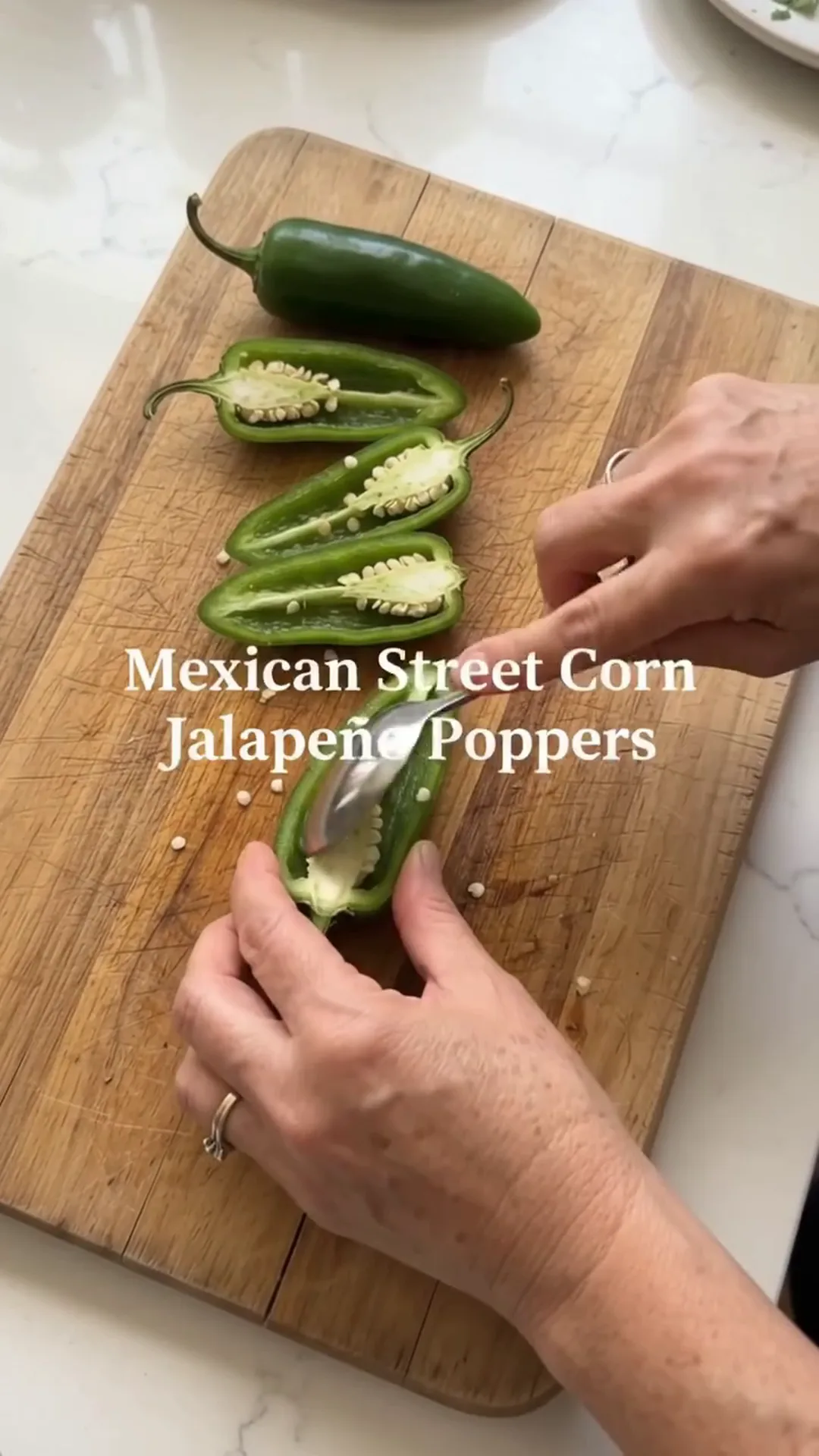 Spicy Mexican Street Corn Jalapeño Poppers Recipe – Someone is preparing Mexican street corn jalapeño poppers