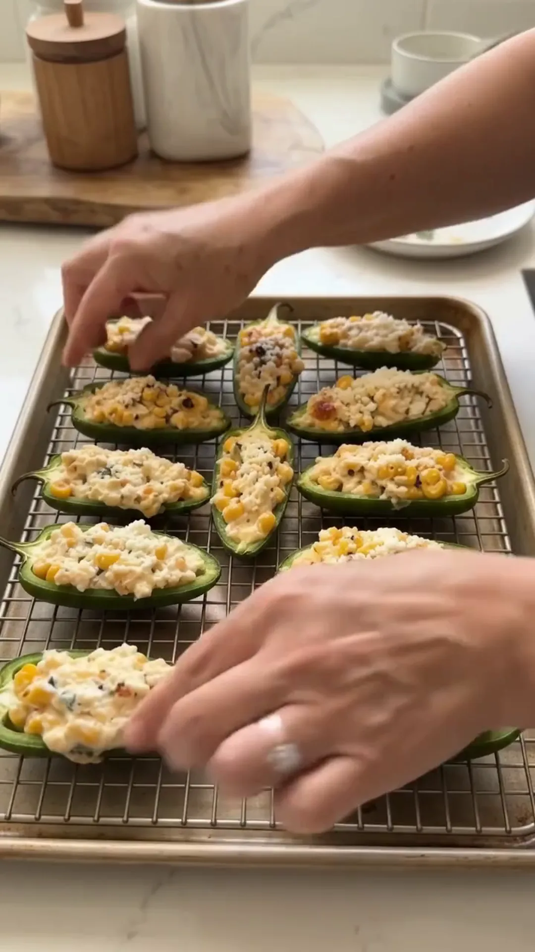 Spicy Mexican Street Corn Jalapeño Poppers Recipe – placing stuffed peppers on a baking tray