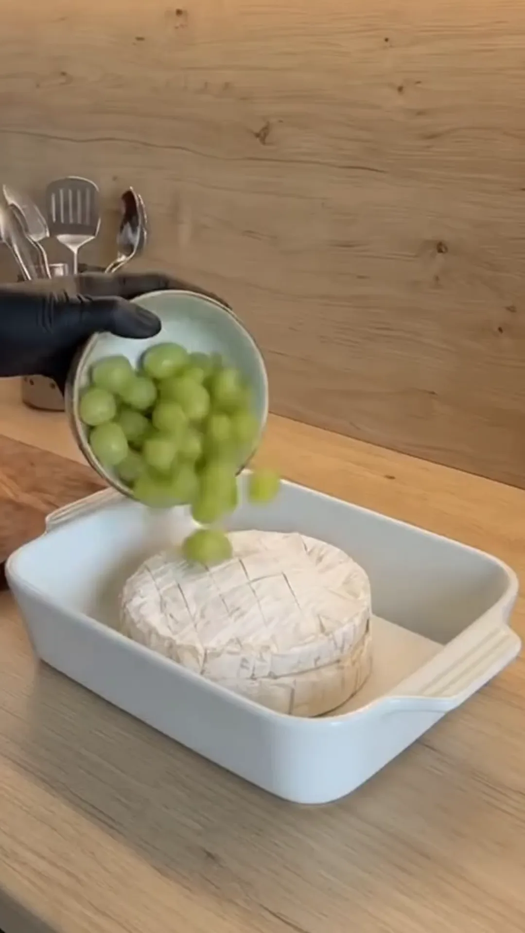 Warm Baked Camembert with Sweet Berries and Roasted Grapes – Pouring grapes over a wheel of cheese