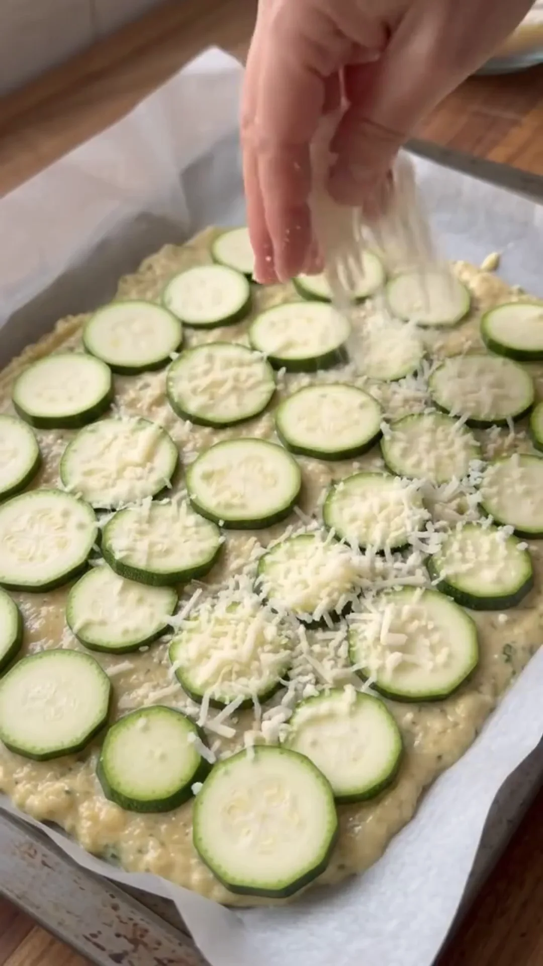 Zucchini Tawouk Flatbread with Savory Chicken – Sprinkling cheese on a zucchini and egg mixture