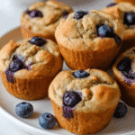 Cottage Cheese Blueberry Muffins close-up on white plate with fresh blueberries