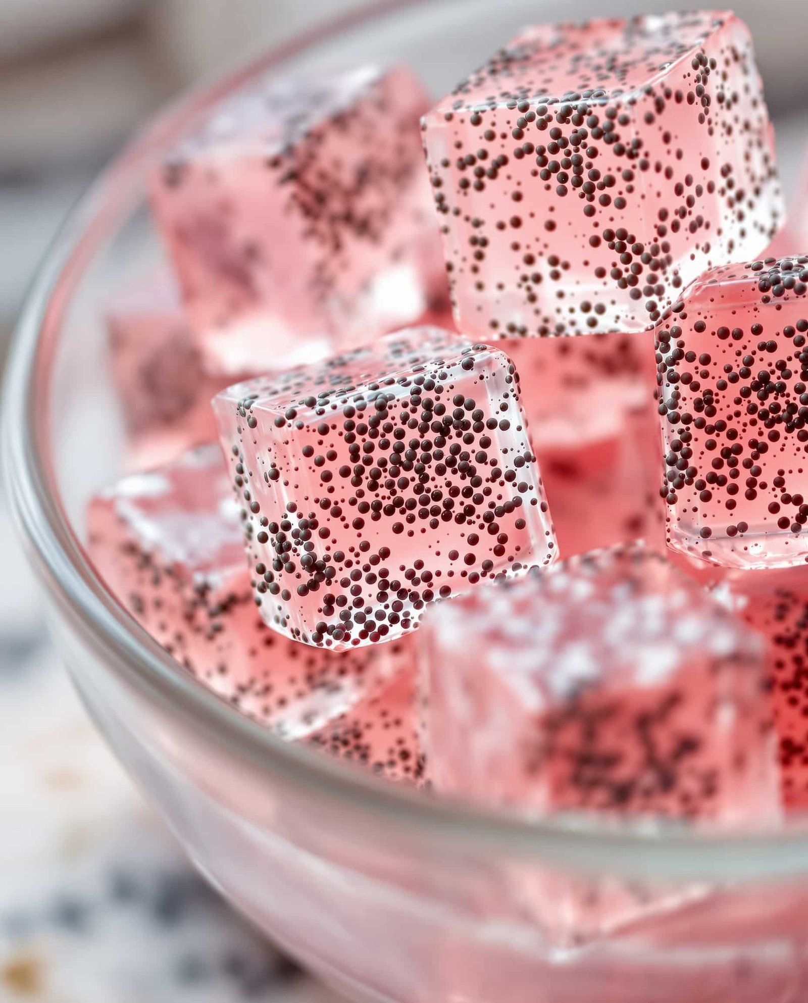Close-up of rose-vert gelatin trick with chia seeds cubes.